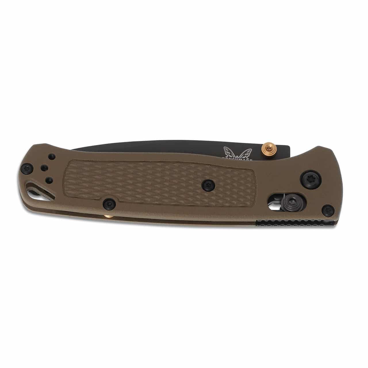 A closed, olive-green folding knife with a black blade. The knife has a textured grip and gold-colored accents near the pivot and locking mechanism. The manufacturer's logo is visible on the blade.