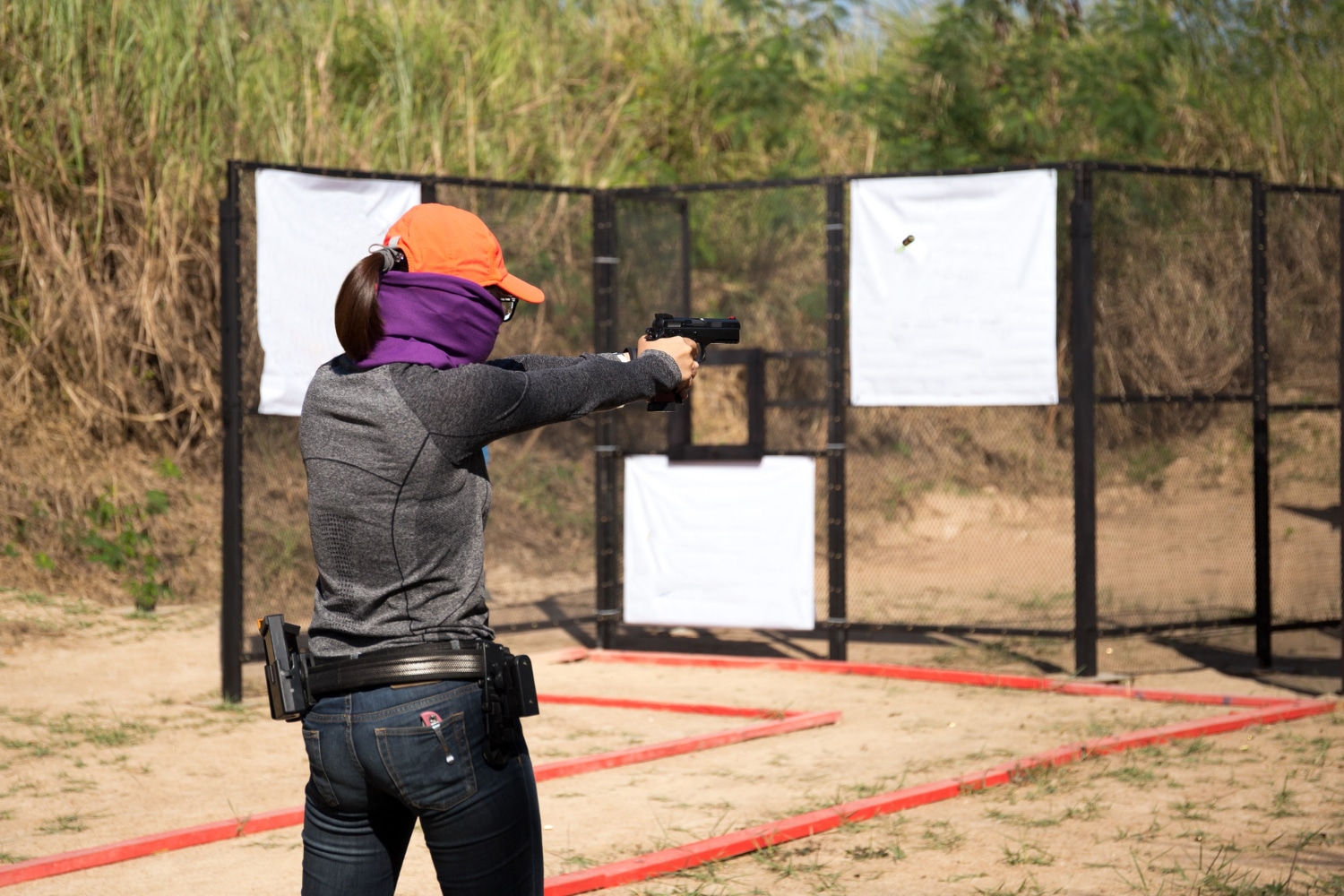 woman aiming pistol