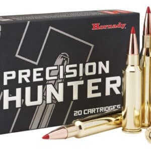 A box of Hornady Precision Hunter cartridges with three rounds displayed in front.