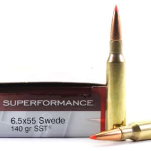 A Hornady Superformance 6.5x55 Swede rifle cartridge box with two cartridges beside it.