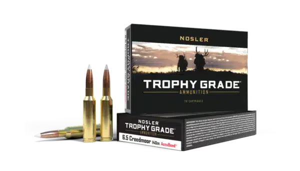 Box of Nosler Trophy Grade ammunition with two rifle cartridges displayed in front.