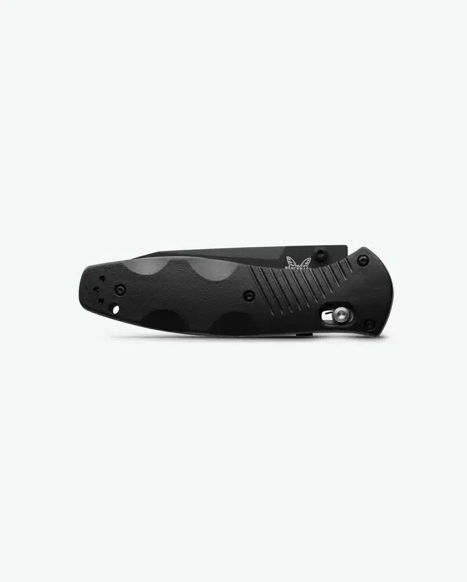 A sleek, closed black pocket knife with textured grips and a logo, resting against a light gray background.