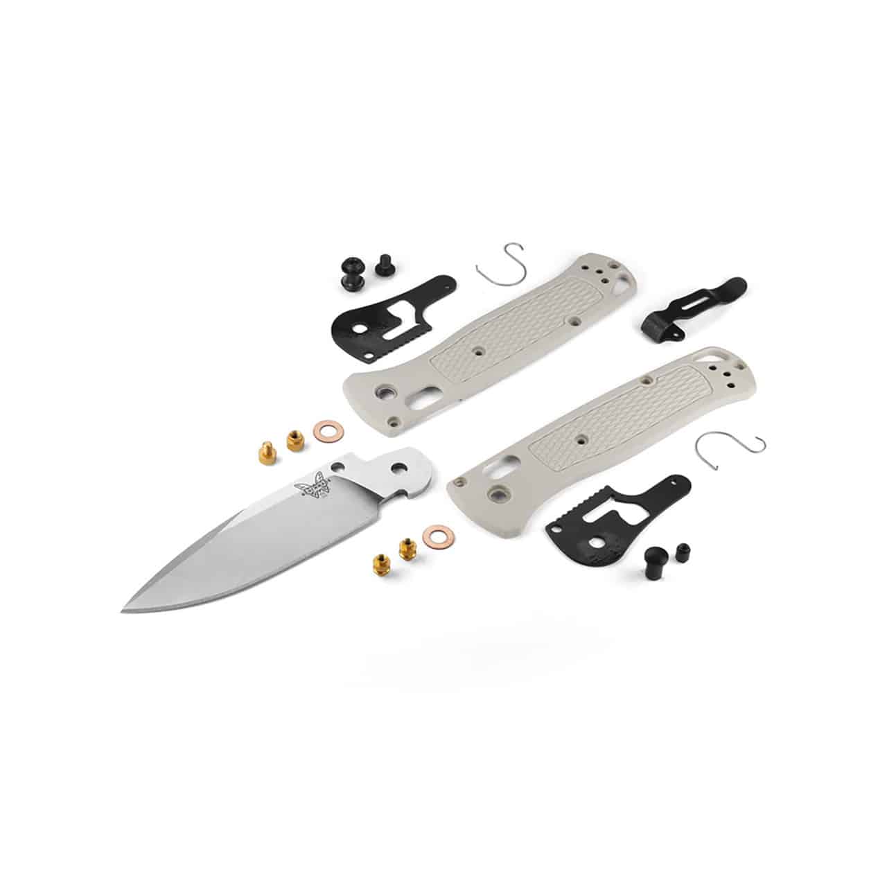 Disassembled pocket knife with components laid out on a white background, including the blade, handle scales, liners, screws, and other hardware.