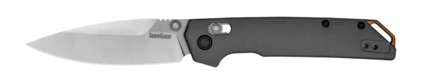 The image depicts a Kershaw folding knife oriented horizontally. The blade is partially open, revealing a polished stainless steel finish with a subtle reflection. The handle, made from a matte black material, has ergonomic contours and a textured surface for grip. Notable features include a thumb stud for one-handed opening, a locking mechanism near the pivot, and a metal pocket clip at the handle's end. The overall composition emphasizes the knife's sleek and modern design.