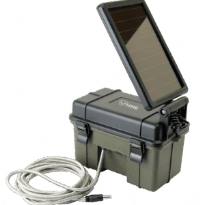 HME TRAIL CAMERA 12V/SOLAR AUXILIARY POWER PACK - An olive green and black solar panel with a matching waterproof container, connected by a silver metallic cable with a black connector; the panel is tilted open, resting on a hinge attached to the top of the container.