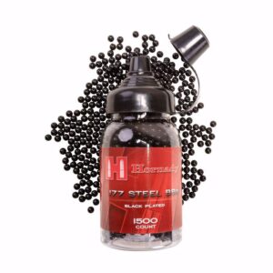 A jar of Hornady .177 steel BBs, black plated, with 1500 count, surrounded by scattered BBs and a cap on top.