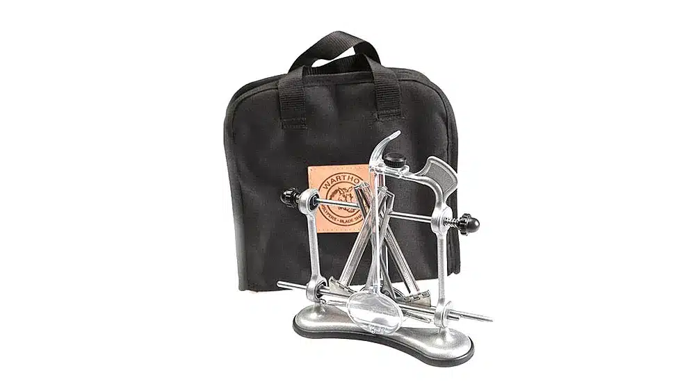 WARTHOG V-SHARP CLASSIC II POUCH - A metal knife sharpener with a base and handle, next to a black carrying case with a logo patch.