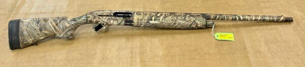 Camo-patterned shotgun with price tag on brown background.