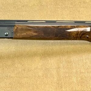 Over-under double-barreled shotgun with a wooden stock and detailed metalwork on a textured background.