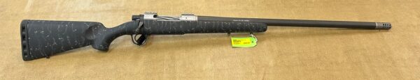 A black rifle with detailed white engraving and with a price tag on a beige background.