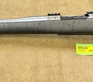 A stainless steel bolt-action rifle with a synthetic stock and attached price tag on a beige background.