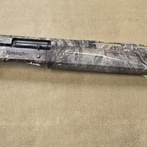 Camo-patterned Remington shotgun on a textured beige background.