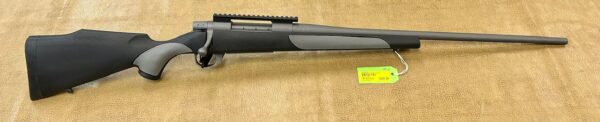 Black shotgun with a price tag on a beige background.