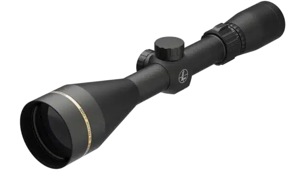 The image presents a black rifle scope angled to display its cylindrical form. The tapered front lens is contrasted by a matte black finish, while a gold accent band runs around the lens housing. The scope features two knobs: a larger parallax adjustment knob near the rear and a smaller elevation adjustment knob directly in line with the scope’s body. The optical components and adjustments indicate its functionality for precise targeting in shooting applications. The background is minimal, emphasizing the scope itself.