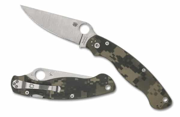 SPYDERCO MILITARY 2 CAMO G-10 PLAINEDGE. A tactical folding knife with a stainless steel blade and a camouflaged handle, partially open and resting beside its closed form.