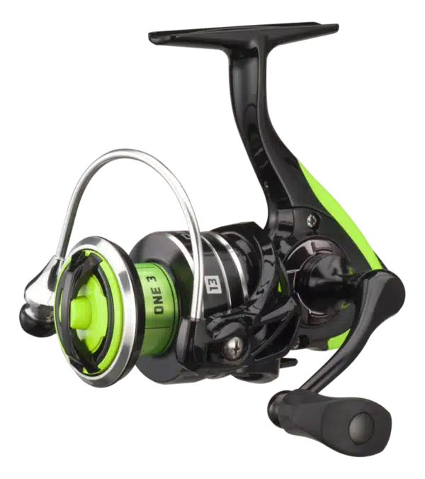 Close-up of a black and green fishing reel with a sleek design, featuring a round spool and a sturdy handle for casting.