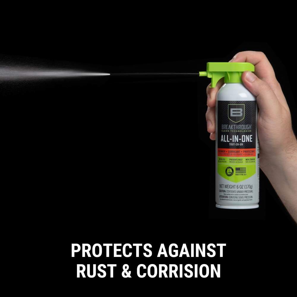 A hand holds a can of Breakthrough All-in-One spray, launching a fine mist, labeled as a rust and corrosion protector.