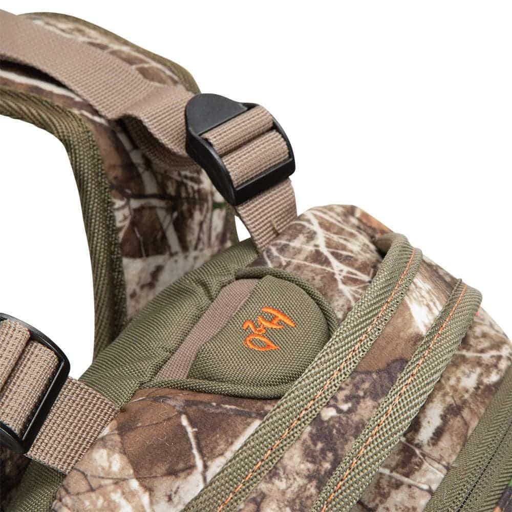 Close-up of a camo-patterned shoulder strap and buckle on an outdoor gear backpack, showcasing durable materials and design.