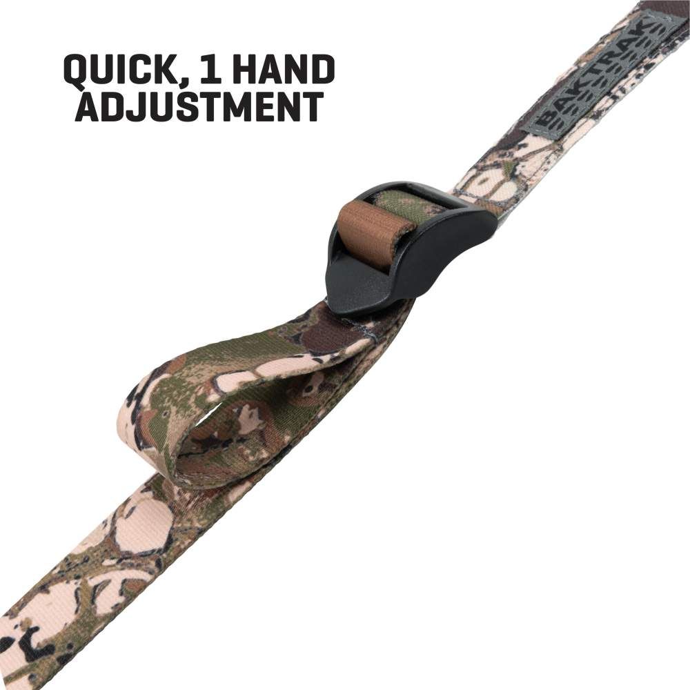 A close-up of a camouflage strap featuring a quick-adjust buckle designed for single-handed operation.