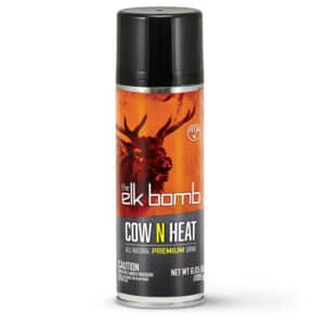 HUNTERS SPECIALTIES BUCK BOMB ELK COW 'N HEAT - A cylindrical can of "the elk bomb COW N HEAT" hunting attractant. The can has a black top, an orange background depicting an elk head, and text reading "COW N HEAT - ALL-NATURAL PREMIUM URINE". A warning and the net weight are printed on the lower portion of the can.