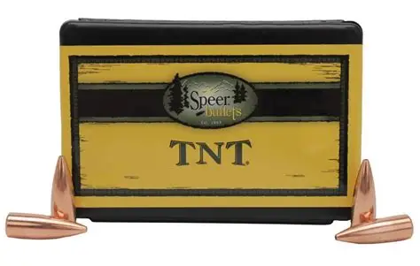 SPEER TNT GREEN BULLET .224 CAL 30 GRAIN - Box of Speer Bullets TNT with four copper bullet projectiles displayed around it on a white background.